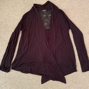 The brand of this cardigan is Rachel, and is black.